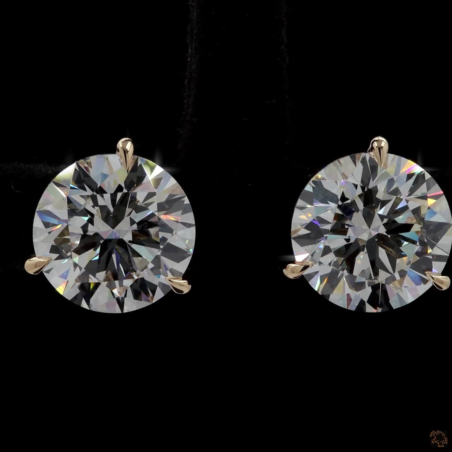 8.10 Ct Pair of solitaire stud earrings featuring round brilliant-cut diamonds