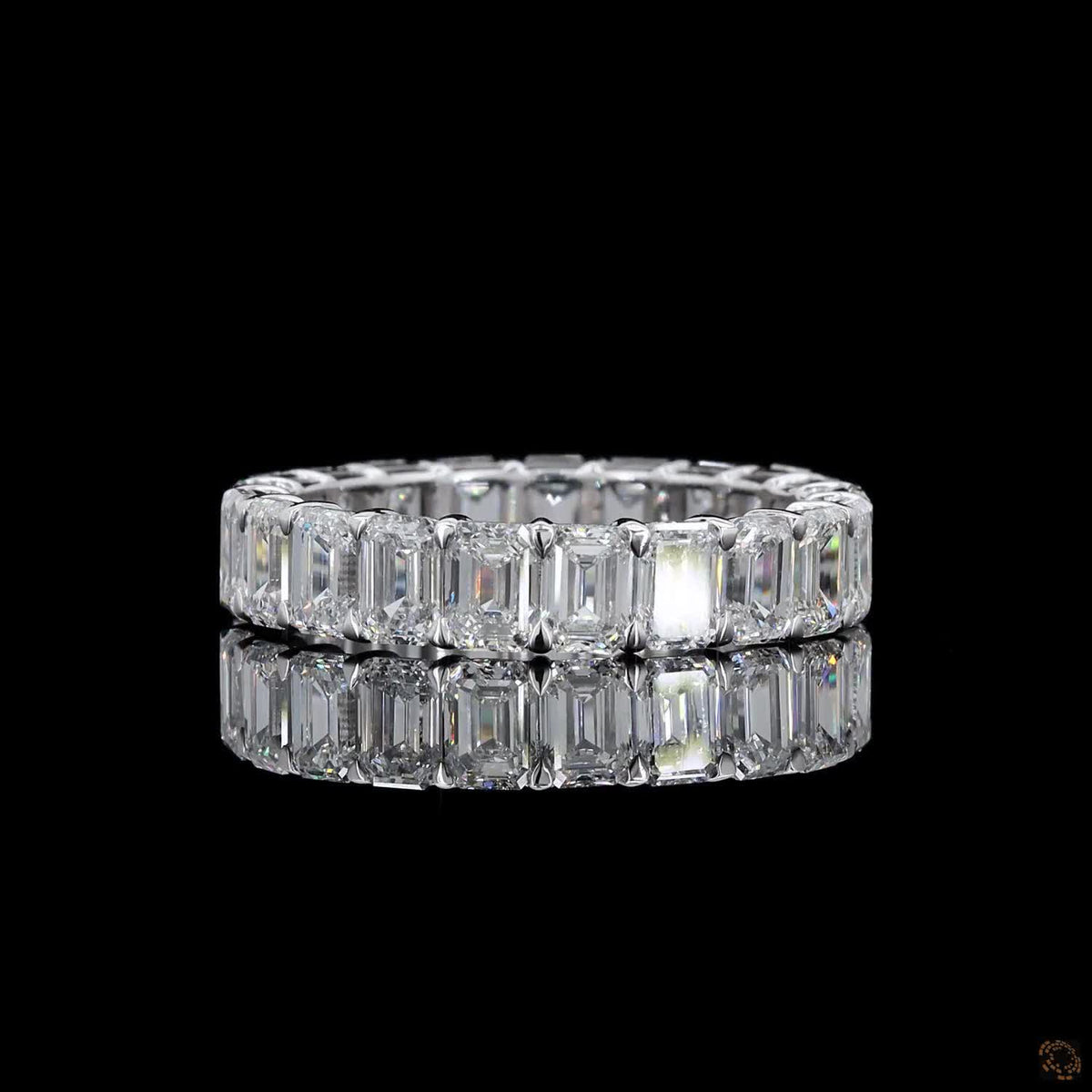 5.39 Ct Step-cut Emerald Diamonds continuously set around the full band