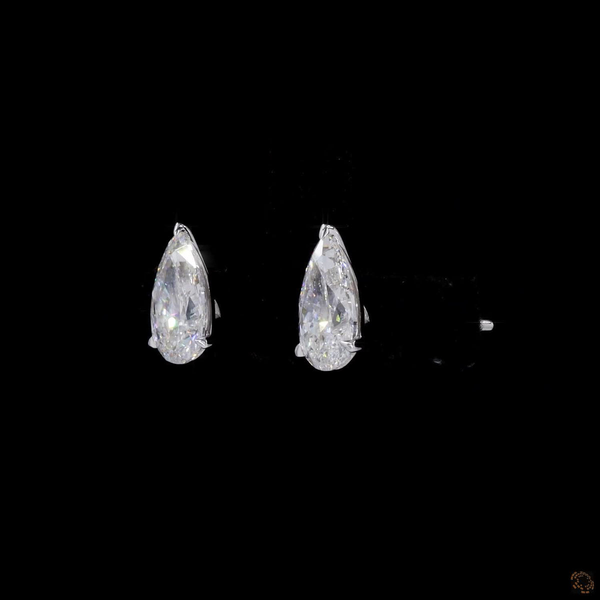 2.18 Ct Enhance your look with sleek bezel-set pear-cut solitaire diamond stud earrings in white gold, featuring a protective metal rim setting and comfortable push-back closures