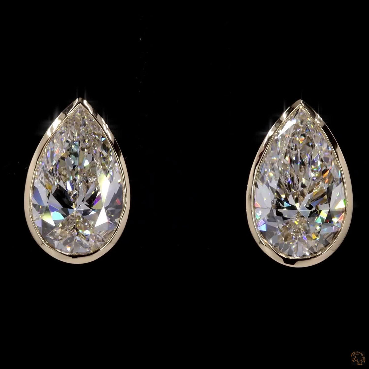 3.04 Ct Upgrade your signature collection with sleek bezel-set pear-cut solitaire diamond stud earrings in yellow gold, featuring a protective metal rim setting and comfortable push-back closures
