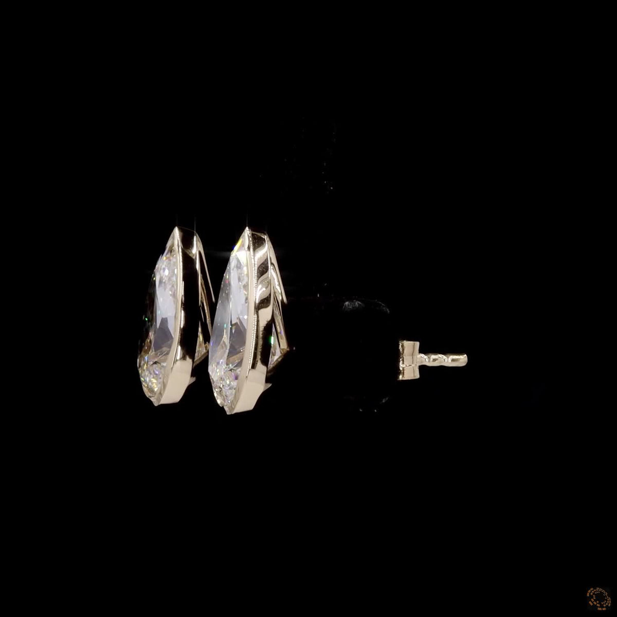 3.04 Ct Upgrade your signature collection with sleek bezel-set pear-cut solitaire diamond stud earrings in yellow gold, featuring a protective metal rim setting and comfortable push-back closures