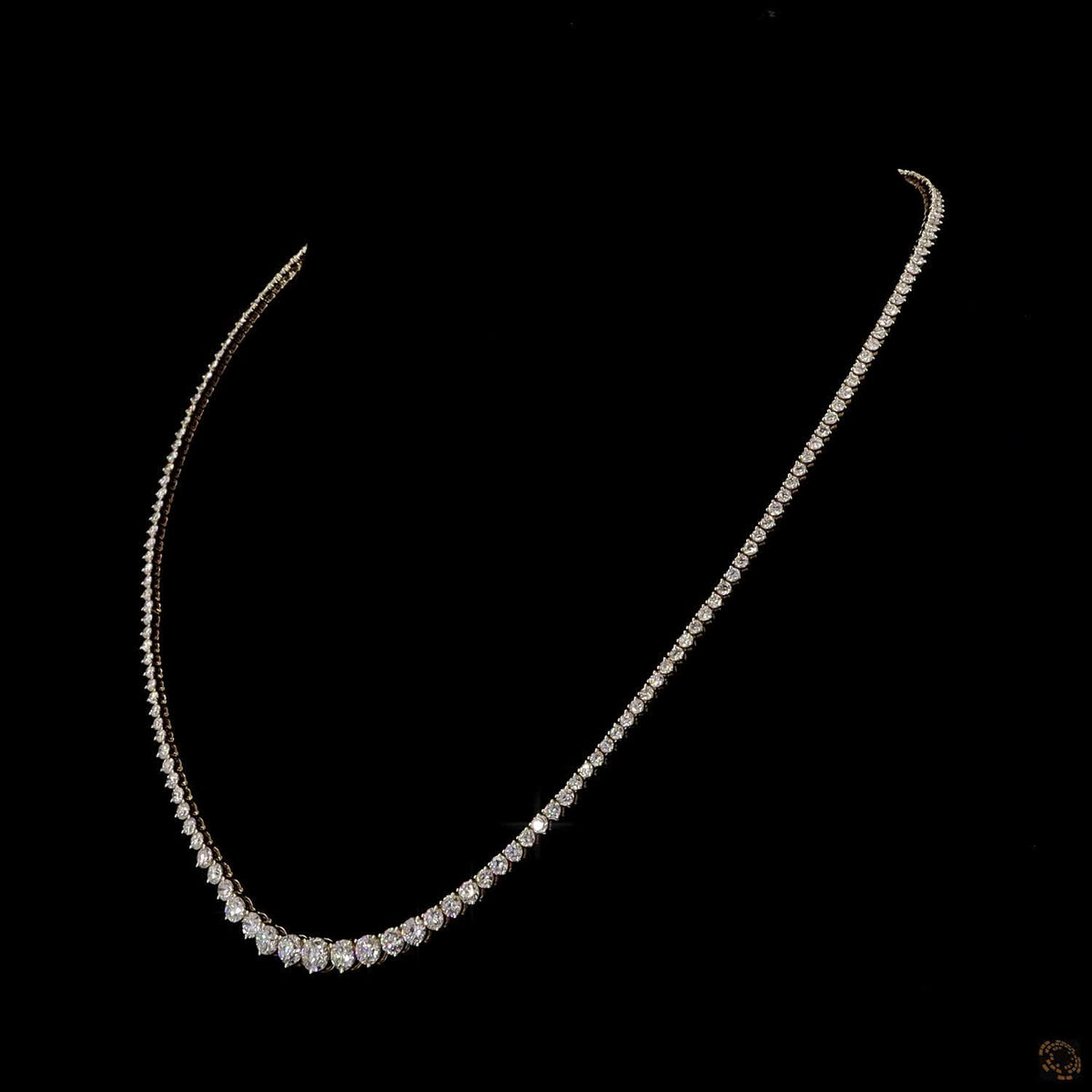 16.21 Ct Traditional Riviera-style tennis necklace defined by a smooth, proportional graduation of diamonds ending in a prominent center stone