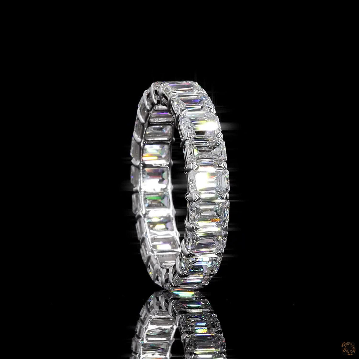 5.39 Ct Step-cut Emerald Diamonds continuously set around the full band